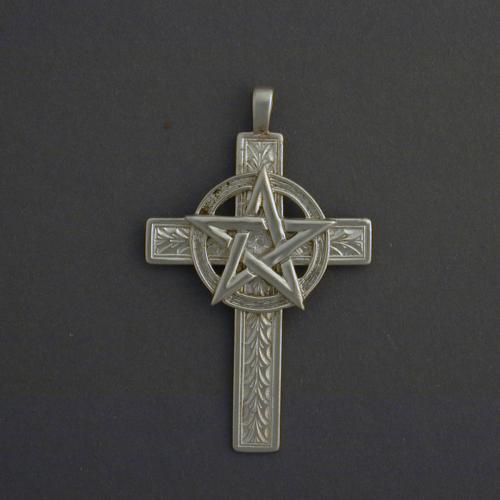 This 1 1/2 inch cross has a discreet foral pattern and a half inch pentagram.