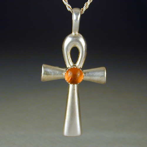 This ankh has a lovely piece of amber set on it. This piece is also available in other cabochon stones.